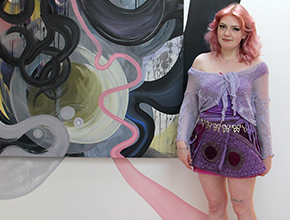 Student stood in front of artwork